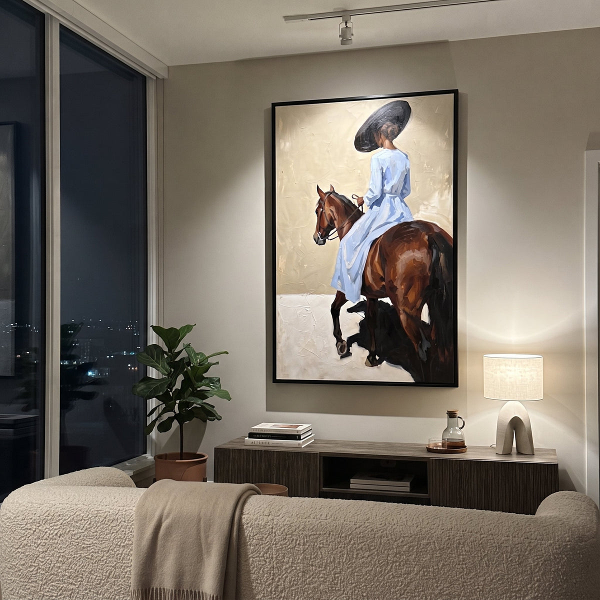 Blue Rider Horse Turn focuses on blue rider horse turn with pale blue dress, broad black hat, brown horse body, reins, shadows, and cream studio ground. The composition is built from the exact pose, clothing shape, accessories, furniture, animal form, shoreline, palm shape, surfboard, or table arrangement visible in this artwork, so the image reads as a specific modern figurative painting rather than a generic decorative abstract. The blue; brown; cream palette gives the piece its main