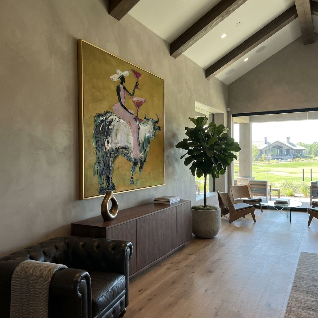 Pink Bull Martini Rider focuses on pink-clad cowgirl on grey bull lifting a martini against mustard ground. The composition is built from the exact pose, clothing shape, accessories, furniture, animal form, shoreline, palm shape, surfboard, or table arrangement visible in this artwork, so the image reads as a specific modern figurative painting rather than a generic decorative abstract. The pink; mustard; grey palette gives the piece its main atmosphere, while smaller dark and light accents